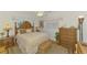 Inviting bedroom with a wooden bed frame, tropical decor, and warm lighting, creating a relaxing atmosphere at 142 Rotonda Cir, Rotonda West, FL 33947