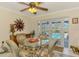 Dining area with wicker furniture and view of the pool area at 142 Rotonda Cir, Rotonda West, FL 33947