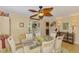 Open dining room featuring a decorative ceiling fan, seating for six, and laminate flooring at 142 Rotonda Cir, Rotonda West, FL 33947