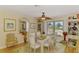 Bright dining room boasts lots of natural light, ceiling fan and seating for six at 142 Rotonda Cir, Rotonda West, FL 33947