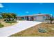Well-maintained single-Gathering home with mature landscaping, charming front porch, and a two-car garage at 142 Rotonda Cir, Rotonda West, FL 33947