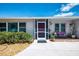 Inviting front porch with bench seating, a screened entry, and colorful plants, adding curb appeal to the home at 142 Rotonda Cir, Rotonda West, FL 33947