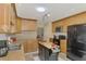 Bright kitchen with skylight, island, stainless appliances and wood cabinetry at 142 Rotonda Cir, Rotonda West, FL 33947