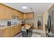 Kitchen with skylight, island, modern appliances, and light wood cabinets at 142 Rotonda Cir, Rotonda West, FL 33947
