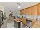 Bright kitchen featuring center island, stainless appliances, and open dining area at 142 Rotonda Cir, Rotonda West, FL 33947