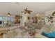 Open concept living room with view to dining area, kitchen, and pool at 142 Rotonda Cir, Rotonda West, FL 33947