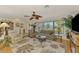Bright living room with large windows, ceiling fan, and comfortable seating at 142 Rotonda Cir, Rotonda West, FL 33947