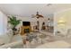 Cozy living room with fireplace, ceiling fan, and open access to the dining area at 142 Rotonda Cir, Rotonda West, FL 33947