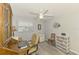 Well-lit office space with a ceiling fan, desk, and storage, perfect for a productive work environment at 142 Rotonda Cir, Rotonda West, FL 33947