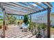 Cozy outdoor patio with pergola, seating area, and lush greenery, perfect for enjoying the serene surroundings at 142 Rotonda Cir, Rotonda West, FL 33947