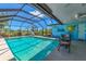 Screened pool area featuring ample space, ceiling fans and beautiful view of the golf course at 142 Rotonda Cir, Rotonda West, FL 33947