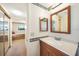 Bathroom with wooden vanity and mirror view into the bedroom at 1515 Forrest Nelson Blvd # N101, Port Charlotte, FL 33952