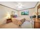 Comfortable bedroom features a ceiling fan, window, and dresser at 1515 Forrest Nelson Blvd # N101, Port Charlotte, FL 33952