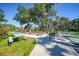 Community picnic and BBQ area with shuffleboard, surrounded by mature trees and manicured landscaping at 1515 Forrest Nelson Blvd # N101, Port Charlotte, FL 33952