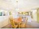 The dining area flows into the kitchen with a wood table set and decorative chandelier at 1515 Forrest Nelson Blvd # N101, Port Charlotte, FL 33952