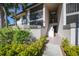 Exterior view of the building with unit numbers and lush landscaping at 1515 Forrest Nelson Blvd # N101, Port Charlotte, FL 33952