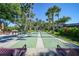 Outdoor shuffleboard court surrounded by benches and lush tropical landscaping, perfect for community recreation at 1515 Forrest Nelson Blvd # N101, Port Charlotte, FL 33952