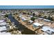 Scenic view of a waterway lined with private docks, boats, and lush tropical landscaping at 159 Godfrey Ne Ave, Port Charlotte, FL 33952