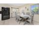 Cozy dining room with a wooden table set, a buffet cabinet, and a large black refrigerator at 159 Godfrey Ne Ave, Port Charlotte, FL 33952