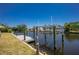Private dock on a canal with a boat lift and a clear blue sky above the waterfront property at 159 Godfrey Ne Ave, Port Charlotte, FL 33952