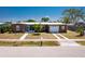 Charming single-story home featuring a well-maintained lawn, mature trees, and an attached garage at 159 Godfrey Ne Ave, Port Charlotte, FL 33952