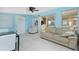Living room with a leather sofa, a ceiling fan, and sliding glass doors at 159 Godfrey Ne Ave, Port Charlotte, FL 33952