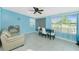 Inviting living room featuring a beige sofa, a modern ceiling fan, and ample natural light at 159 Godfrey Ne Ave, Port Charlotte, FL 33952