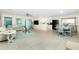 Spacious living room with tile flooring, ceiling fan, and modern decor at 159 Godfrey Ne Ave, Port Charlotte, FL 33952