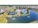 Enjoying an aerial view of the community clubhouse, pool, and tennis courts at 1678 Royal Ct, Punta Gorda, FL 33980