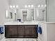 Elegant bathroom with double vanity, dark wood cabinets, and a glass-enclosed shower at 1678 Royal Ct, Punta Gorda, FL 33980