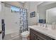 Cozy bathroom with tile floors, a shower-tub combo, and a charming floral shower curtain at 1678 Royal Ct, Punta Gorda, FL 33980