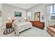 Cozy bedroom with neutral walls, tile flooring, and ample natural light from the windows at 1678 Royal Ct, Punta Gorda, FL 33980