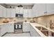 Beautiful kitchen with stainless steel appliances, elegant countertops, and ample storage in white cabinets at 1678 Royal Ct, Punta Gorda, FL 33980