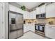 Spacious kitchen featuring stainless steel appliances, white cabinets, tiled backsplash, and ample counter space at 1678 Royal Ct, Punta Gorda, FL 33980