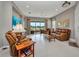 Well-lit living room with comfortable furniture, tile flooring, and scenic backyard views at 1678 Royal Ct, Punta Gorda, FL 33980