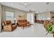 Open concept living room with tile floors, leather seating, and a bright, inviting atmosphere at 1678 Royal Ct, Punta Gorda, FL 33980