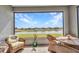 Enclosed patio features wicker chairs and table with beautiful water view at 1678 Royal Ct, Punta Gorda, FL 33980