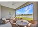 Relaxing screened patio with wicker furniture and a scenic water view at 1678 Royal Ct, Punta Gorda, FL 33980