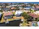 Aerial view of waterfront home with private dock, surrounded by lush landscaping at 1711 Boca Raton Ct, Punta Gorda, FL 33950
