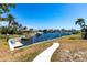 Lush backyard with seating area along the waterfront at 1711 Boca Raton Ct, Punta Gorda, FL 33950