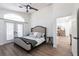 Inviting bedroom with vaulted ceiling, French doors, and stylish furnishings for relaxation at 1711 Boca Raton Ct, Punta Gorda, FL 33950