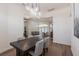 Elegant dining room with a wooden table, upholstered chairs, and modern lighting at 1711 Boca Raton Ct, Punta Gorda, FL 33950