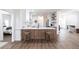Bright kitchen features a peninsula, stools, and white cabinets, offering a modern and inviting space at 1711 Boca Raton Ct, Punta Gorda, FL 33950