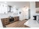 Modern kitchen features stainless steel appliances, white cabinets, and wood flooring for a stylish look at 1711 Boca Raton Ct, Punta Gorda, FL 33950