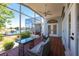 Outdoor lanai featuring waterfront views, comfortable seating, and ceiling fan for relaxed entertainment at 1711 Boca Raton Ct, Punta Gorda, FL 33950