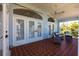 Inviting lanai with tile floors, ceiling fan, and comfortable seating arrangement perfect for relaxation at 1711 Boca Raton Ct, Punta Gorda, FL 33950