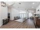 Open-concept living room with wood flooring, a gray sofa, and natural light at 1711 Boca Raton Ct, Punta Gorda, FL 33950