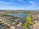 Aerial view highlighting the community, pond, and manicured lawns of the neighborhood at 17459 Palmetto Pass Ln, Punta Gorda, FL 33982