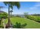 Well-maintained backyard overlooking a tranquil pond, with lush landscaping creating a serene outdoor retreat at 17459 Palmetto Pass Ln, Punta Gorda, FL 33982