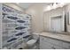 Bright bathroom featuring a single granite sink vanity and a shower with a decorative fish curtain at 17459 Palmetto Pass Ln, Punta Gorda, FL 33982